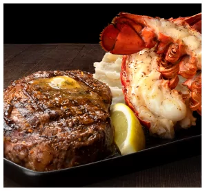 Steak and lobster plate at MR MIKES served with mashed potatoes and lemon