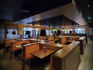 Updated booth seating inside a MR MIKES SteakhouseCasual restaurant after conversion in Canada